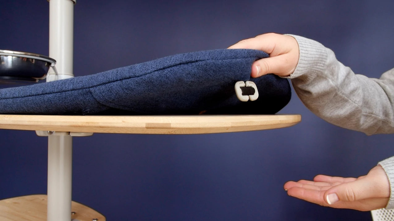Cat tree cushion being removed for cleaning